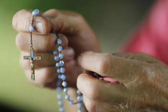 Framed Print : Close-up of a mans hands praying the rosary, France, Europe Framed Print : Close-up of a mans hands praying the rosary, France, Europe