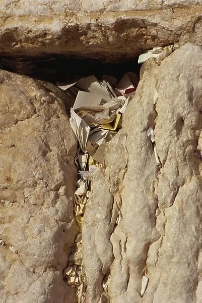 Close-up of notes and prayers placed in a crack on the Western Wall in Jerusalem