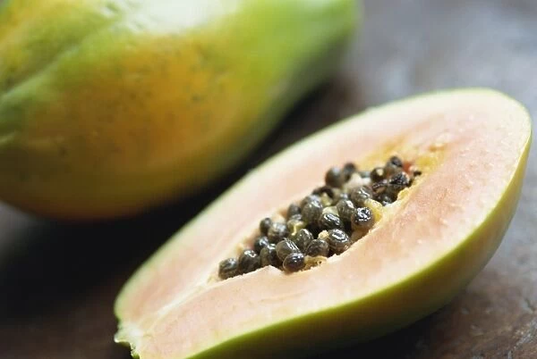 Close-up of a papaya sliced in half showing black seeds inside