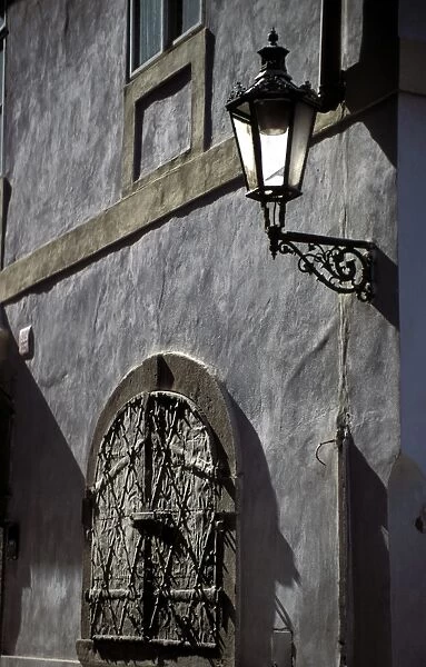 Close-up of shutters and lamp on a wall in Tynska Street, Prague, Czech Republic, Europe