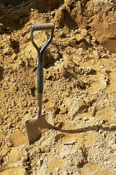 Close-up of spade in sand on a building site, City of London, England, United Kingdom