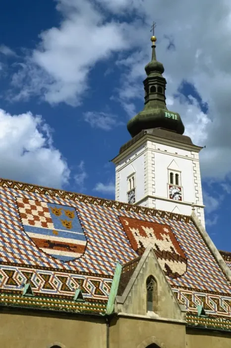 Framed Print : Close-up of tile roof with pattern of shields and clock tower of St. Marks church Framed Print : Close-up of tile roof with pattern of shields and clock tower of St. Marks church