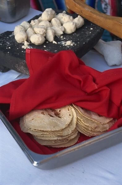 Close-up of tortillas in a tray covered by a red cloth