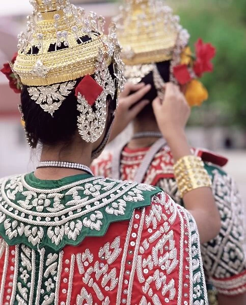 Close-up of the back view of two dancers in traditional