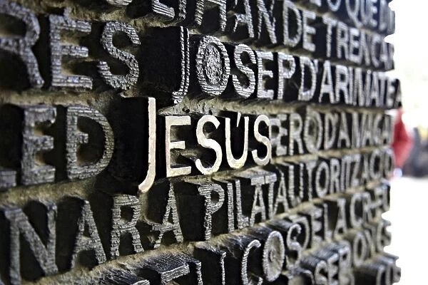 Close up of writing which fills the bronze doors of the Sagrada Familia
