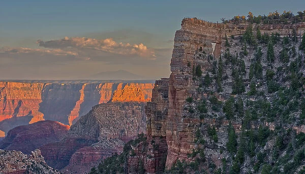 Closeup of Angel's Window at Cape Royal on North Rim above Unker Creek near sundown, with brown haze on the horizon smoke from a wildfire near the park, Grand Canyon National Park, UNESCO World Heritage Site, Arizona, United States of America