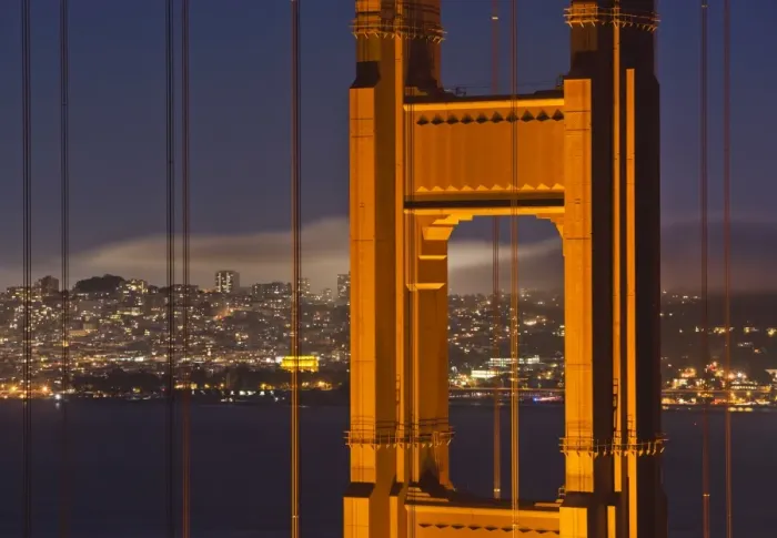 Framed Print : Closeup view of the north tower of the Golden Gate Bridge at sunset with the San Francisco city skyline, San Francisco, California, United States of America Framed Print : Closeup view of the north tower of the Golden Gate Bridge at sunset with the San Francisco city skyline, San Francisco, California, United States of America
