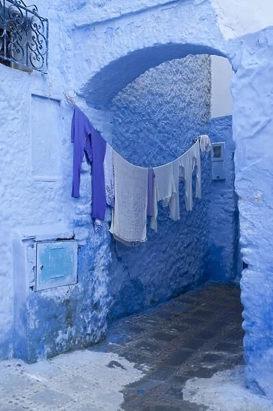 Clothes drying in a typical house entrance, Chefchaouen, Morocco, North Africa, Africa