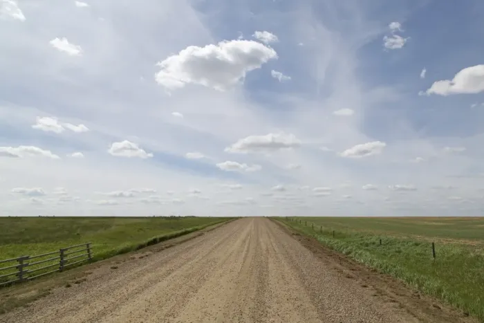 Framed Print : Clouds and blue sky over a dirt track in the Badlands of Alberta, near Drumheller Framed Print : Clouds and blue sky over a dirt track in the Badlands of Alberta, near Drumheller