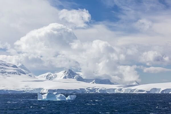 Clouds build over snow-capped mountains in Dallmann Bay, Antarctica, Polar Regions
