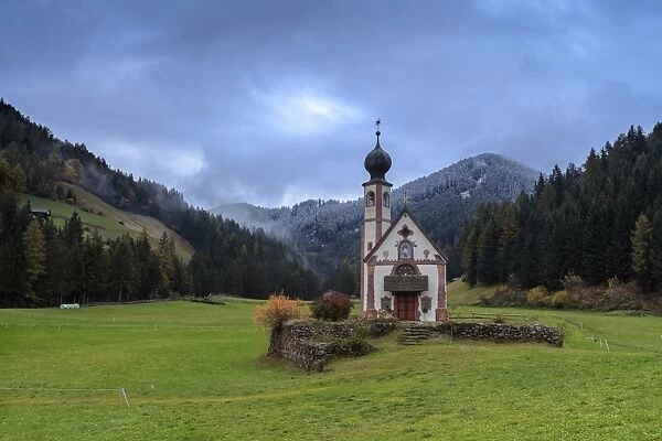 Clouds on Church of Ranui surrounded by meadows and woods in the fall, St. Magdalena