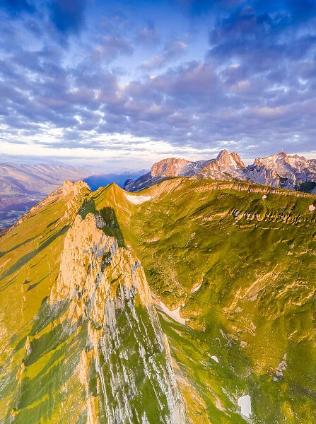 Clouds at dawn over the majestic peaks of Santis and Saxer Lucke, aerial view