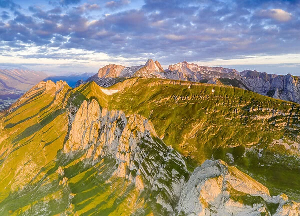 Clouds at dawn over the majestic Santis and Saxer Lucke mountains, aerial view
