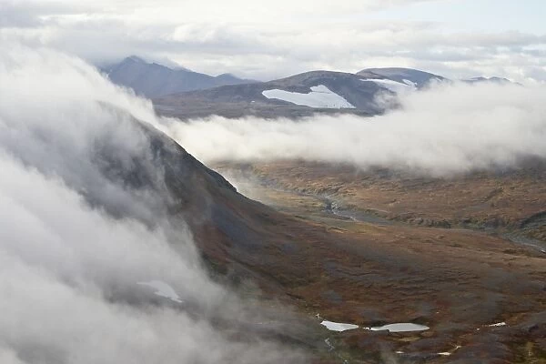 Clouds and mountains and tundra in the fall, Katmai Peninsula, Alaska, United States of America