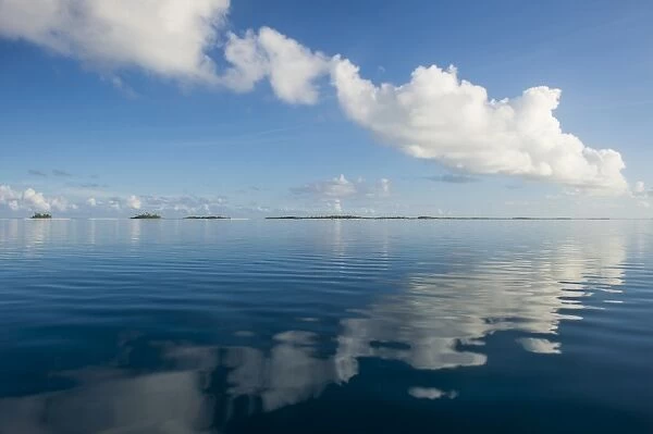 Clouds reflecting in the calm waters of Tikehau, Tuamotus, French Polynesia, Pacific