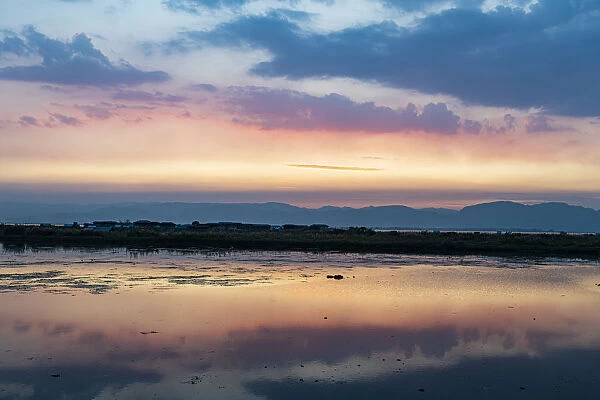 Clouds reflecting in the water at sunset, Inle Lake, Shan state, Myanmar (Burma), Asia