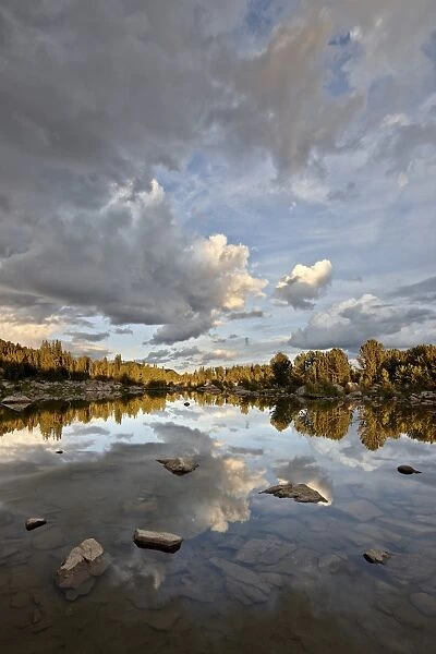 Clouds at sunset reflected in an unnamed lake, Shoshone National Forest, Wyoming, United States of America, North America