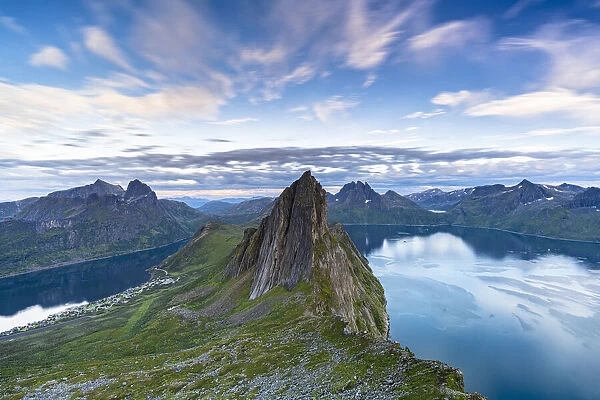 Clouds at sunset over the unspoiled blue water of fjords and Segla Mountain, Senja island