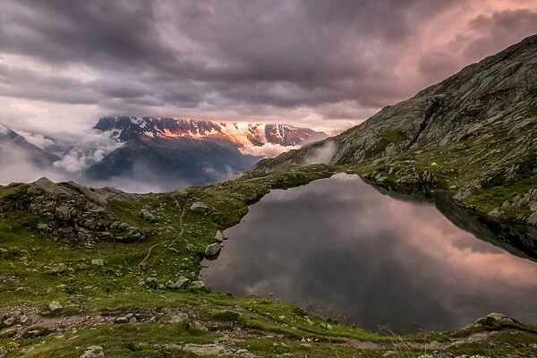 Clouds are tinged with purple at sunset at Lac de Cheserys, Chamonix, Haute Savoie