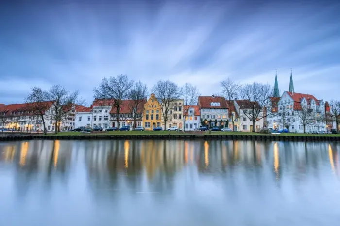 Framed Print : Clouds on the typical houses and towers of cathedral reflected in River Trave at dusk Framed Print : Clouds on the typical houses and towers of cathedral reflected in River Trave at dusk