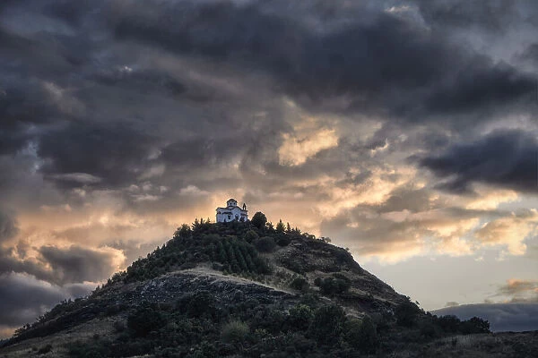 Cloudy sunset on a small church on the top of a hill, Thessaly, Greece, Europe