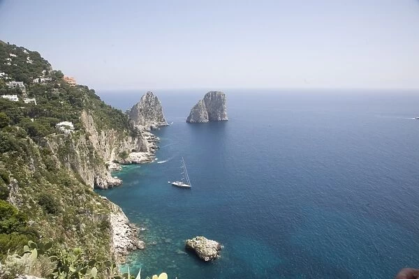 The coast line of the island of Capri, with the famous Faraglioni rocks on the back ground