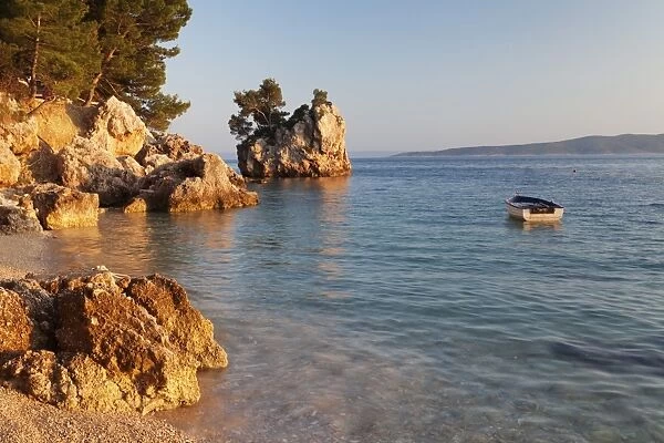 Coastal landscape with a rock and a rowing boat, Brela, Makarska Riviera, Dalmatia, Croatia, Europe