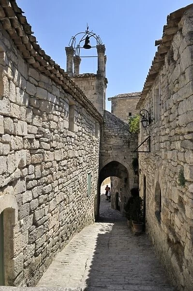 Cobbled alley and bell tower in the picturesque medieval village of Lacoste