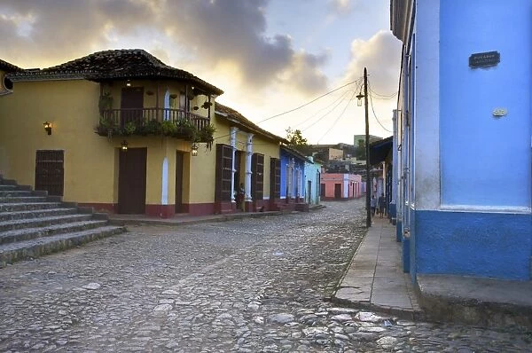 Cobbled street at dusk with brightly painted houses, off Plaza Mayor, Trinidad