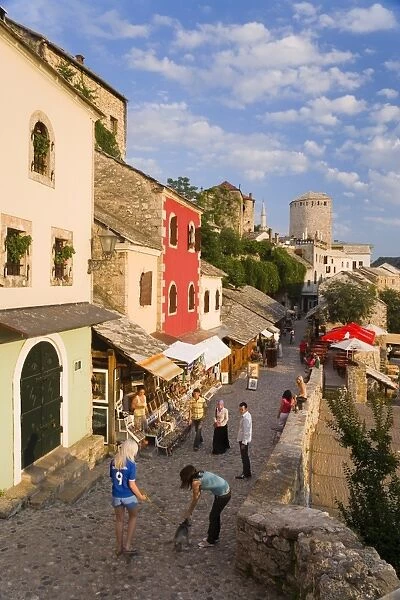 Cobbled street lined with colourful houses known as Kujundziluk, one of the oldest streets in Mostar leading to the Old Bridge, Old Town, UNESCO World Heritage Site, Mostar, Herzegovina, Bosnia