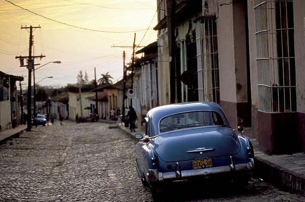 Cobbled street at sunset with old American car, Trinidad, Sancti Spiritus province