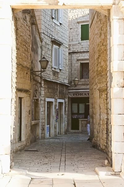 Cobbled streets of Trogir seen through the South Town Gate, Trogir, UNESCO World Heritage Site, Dalmatia, Croatia, Europe