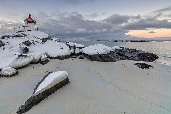 Colorful arctic sunset on the lighthouse surrounded by snow and icy sand, Eggum, Vestvagoy