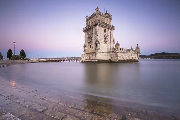 Colorful dusk on the Tower of Belem, UNESCO World Heritage Site, reflected in Tagus River