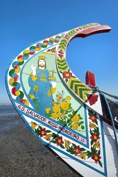 Colorful hand painted prow of a gondola-like moliceiro on the beach, Torreira, Aveiro, Beira, Portugal, Europe