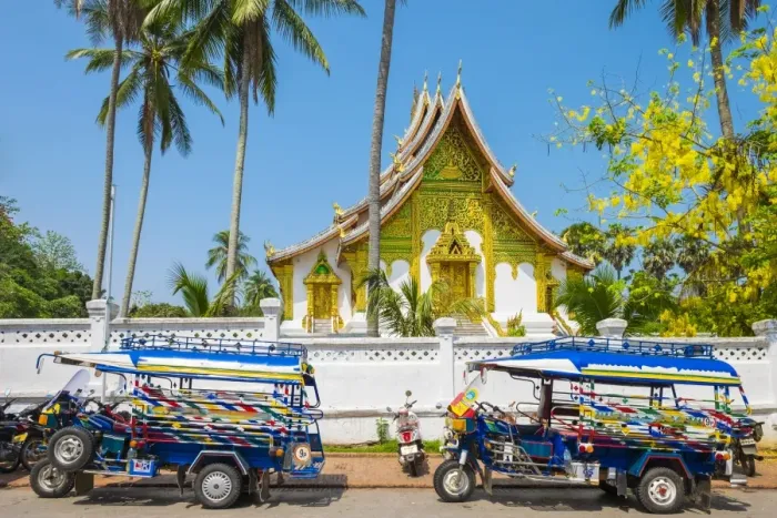 Framed Print : Colorful tuk-tuks in front of Haw Pha Bang temple on the grounds of the Royal Palace Framed Print : Colorful tuk-tuks in front of Haw Pha Bang temple on the grounds of the Royal Palace
