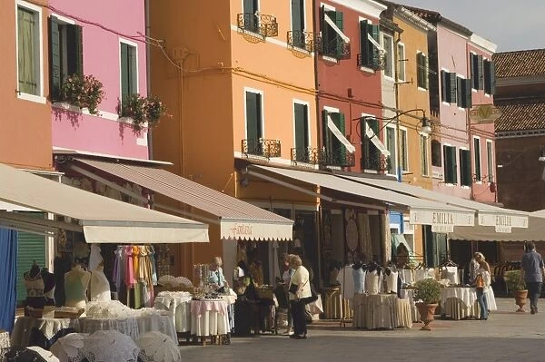 Coloured shopfront houses with pavement displays