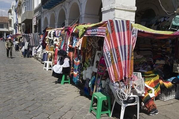 Colourful clothing and textiles for tourists in the market on Plaza San Francisco