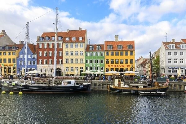 Colourful facades along canal and entertainment district of Nyhavn, Copenhagen, Denmark