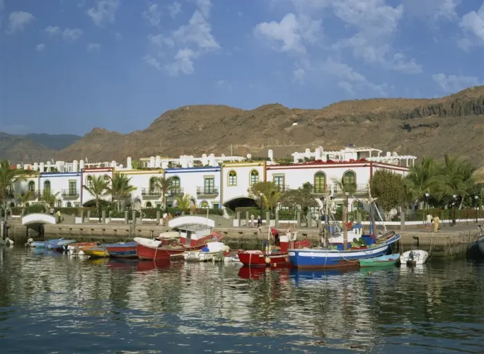 Framed Print : Colourful fishing boats and cottages in the old port area, Puerto de Morgan Framed Print : Colourful fishing boats and cottages in the old port area, Puerto de Morgan