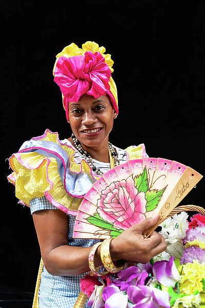 Colourful flower girl with headdress, fan and basket, Havana, Cuba, West Indies, Caribbean, Central America