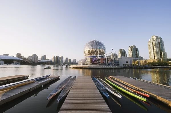 Colourful rowing boats in front of Telus Science World, on False Creek