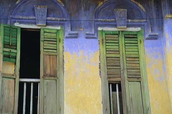 Colourful window shutters in an old builing