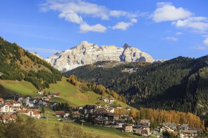 Framed Print : Colourful woods frame the village and the high peaks in autumn, Gardena Pass, South Tyrol Framed Print : Colourful woods frame the village and the high peaks in autumn, Gardena Pass, South Tyrol