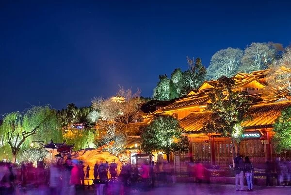 Colourfully illuminated traditional architecture and trees in the old town of Lijiang, UNESCO World Heritage Site, Yunnan province, China, Asia