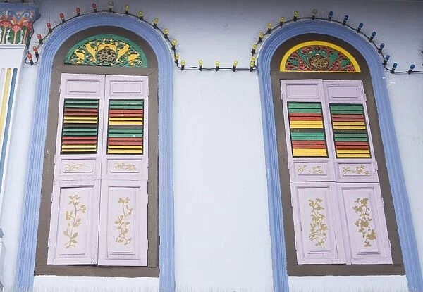 Colourfully painted window shutters in Little India