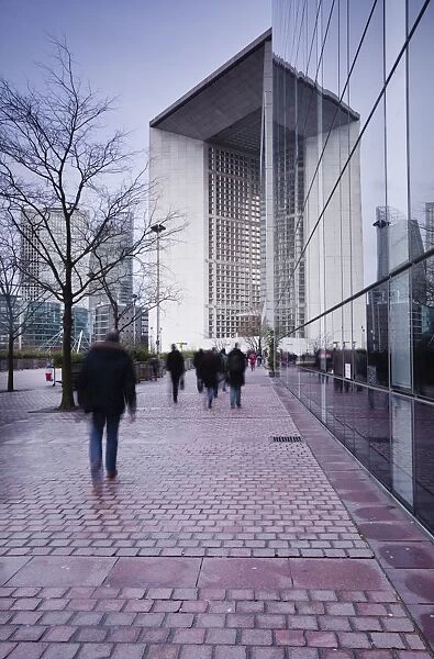 Commuters leaving work in the La Defense area with La Grande Arche in the background, Paris, France, Europe
