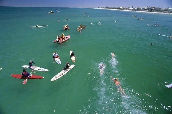 Competitors leaving Grange Pier at the Henley and Grange swimming race that is swum between the piers of these two seaside suburbs of Adelaide, South Australia