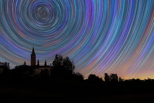 Concentric star trail over a bell tower in the Italian countryside, Emilia Romagna, Italy, Europe