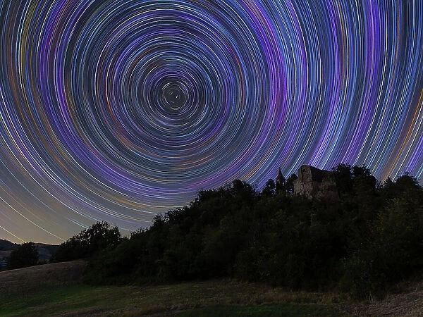 Concentric star trail over a medieval castle in the Italian countryside, Emilia Romagna, Italy, Europe
